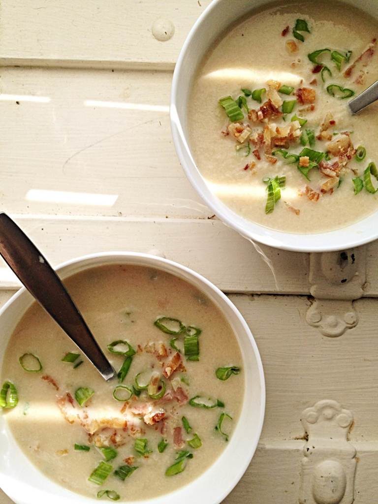 bowls of cauliflower soup with crispy bacon
