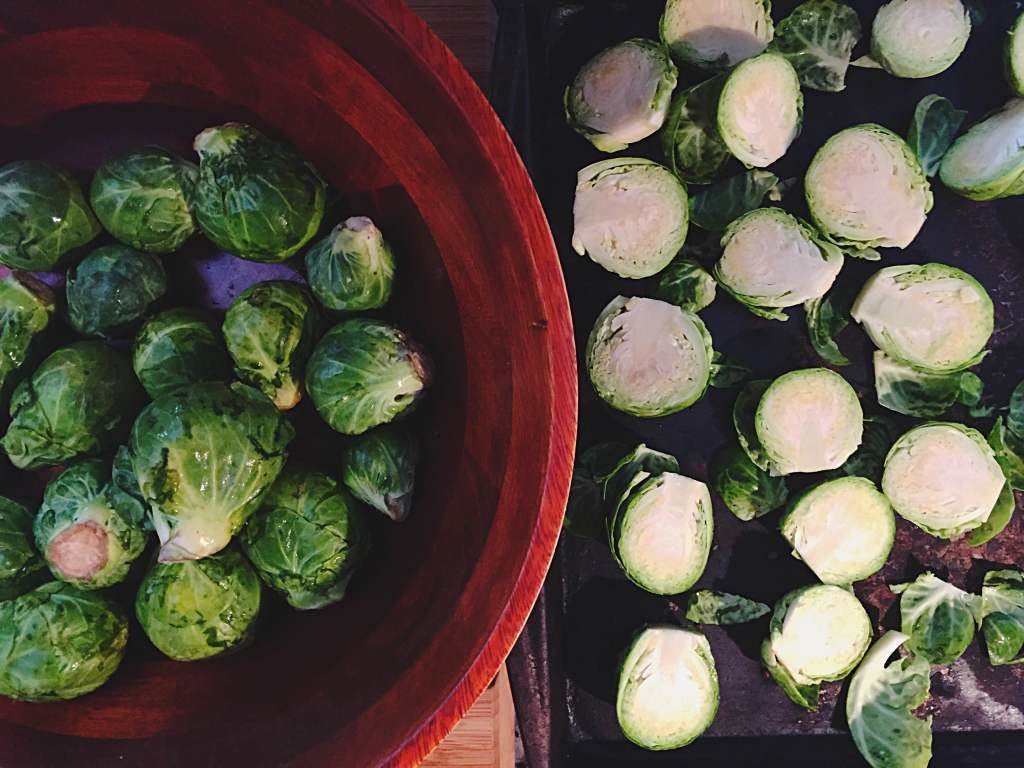 Brussels sprouts in bowl and cut