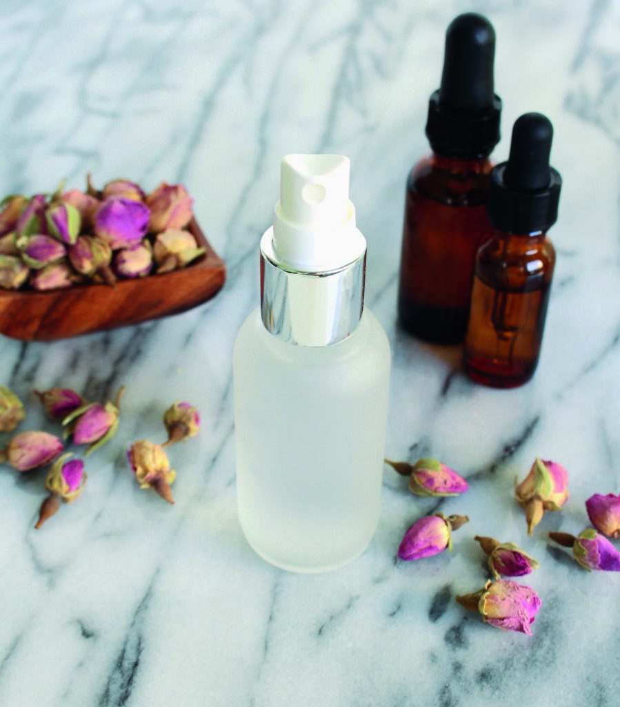 dried roses with spray bottle and serums