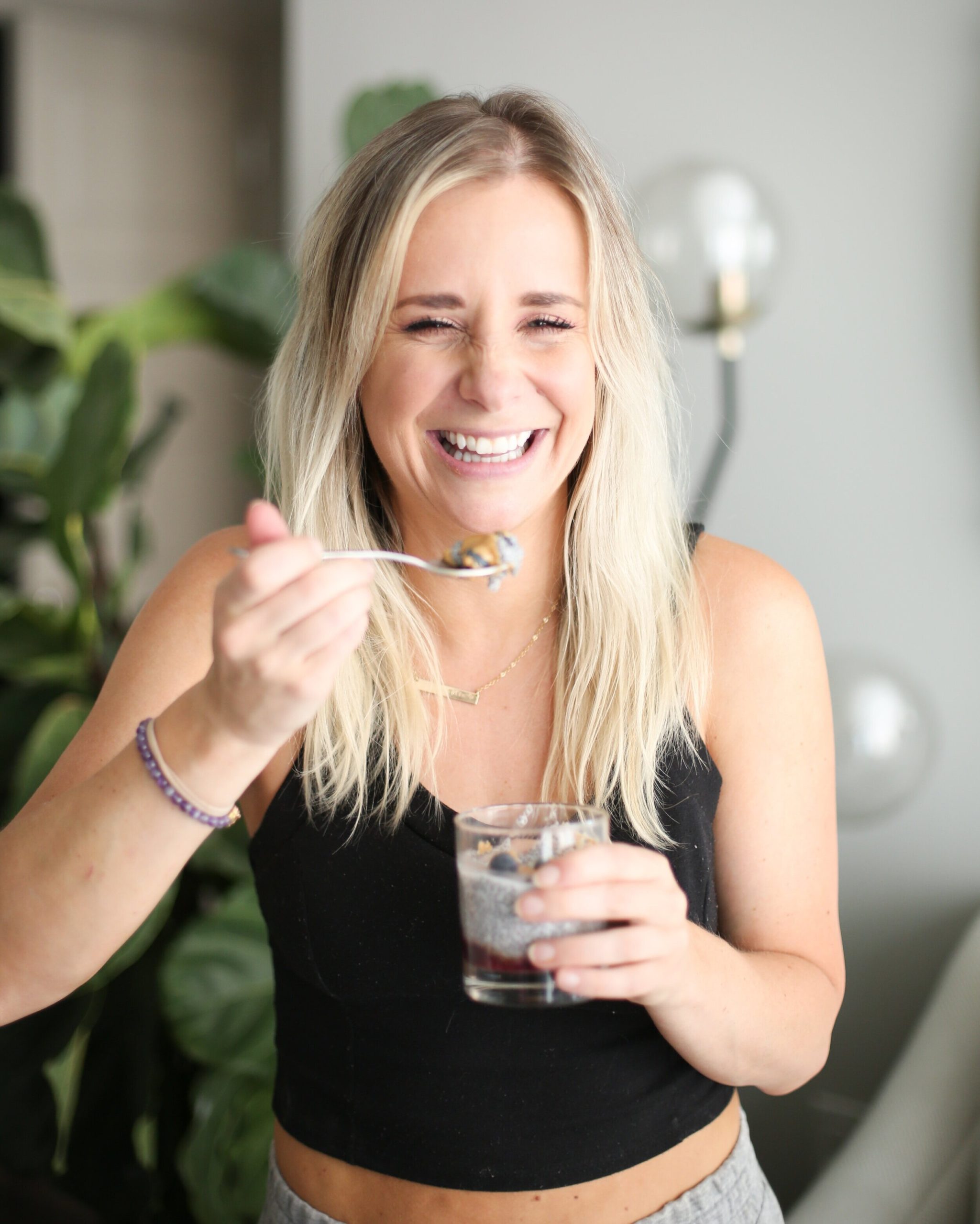 megan laughing and eating blueberry cashew chia pudding