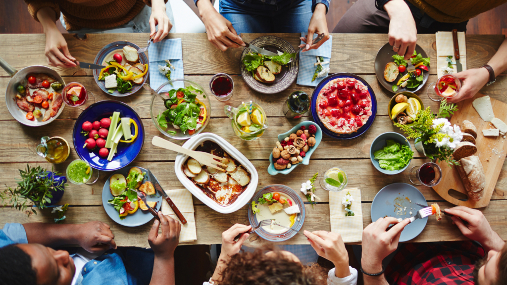 overhead shot of group sharing a meal on a table